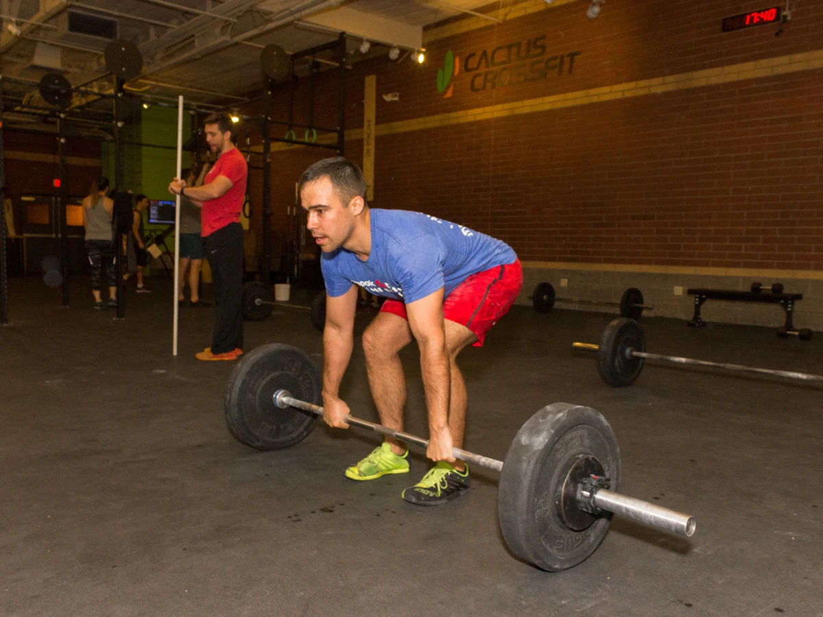 Member training with barbell at Cactus CrossFit